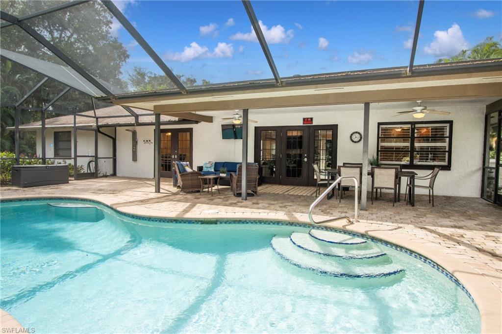 View of pool featuring french doors, ceiling fan, and a patio area