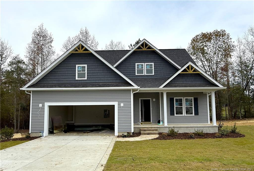 a front view of a house with yard and garage