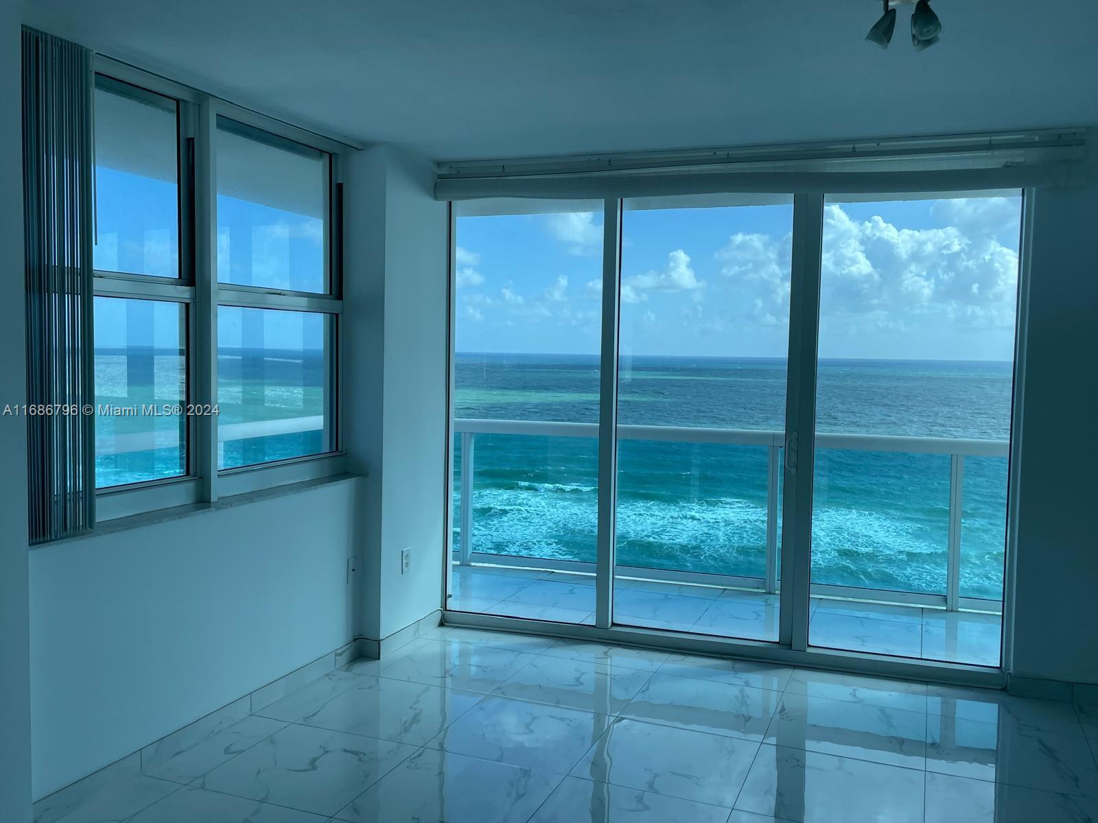 a view of a glass door and an empty room