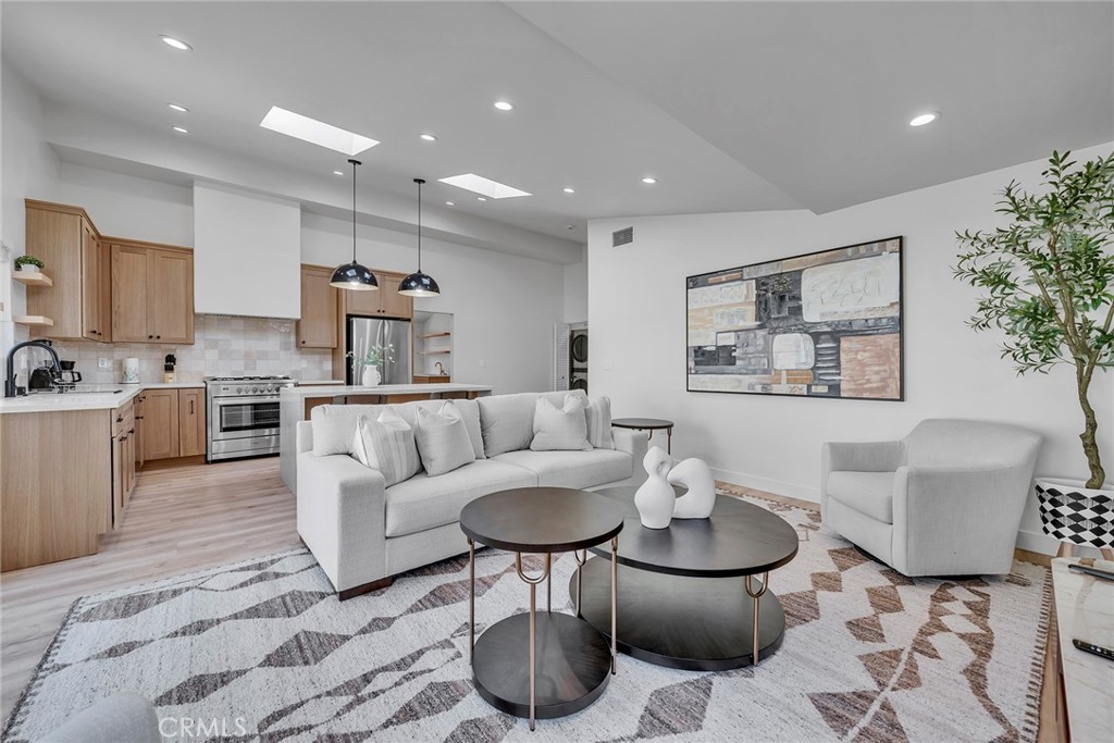 a living room with furniture and a potted plant