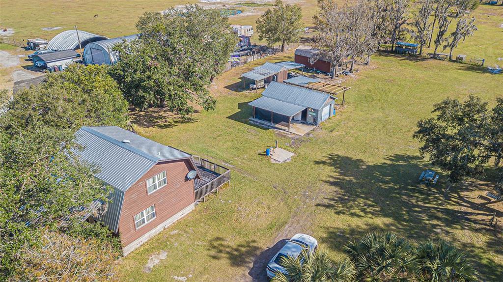 an aerial view of a house with a yard swimming pool and outdoor seating