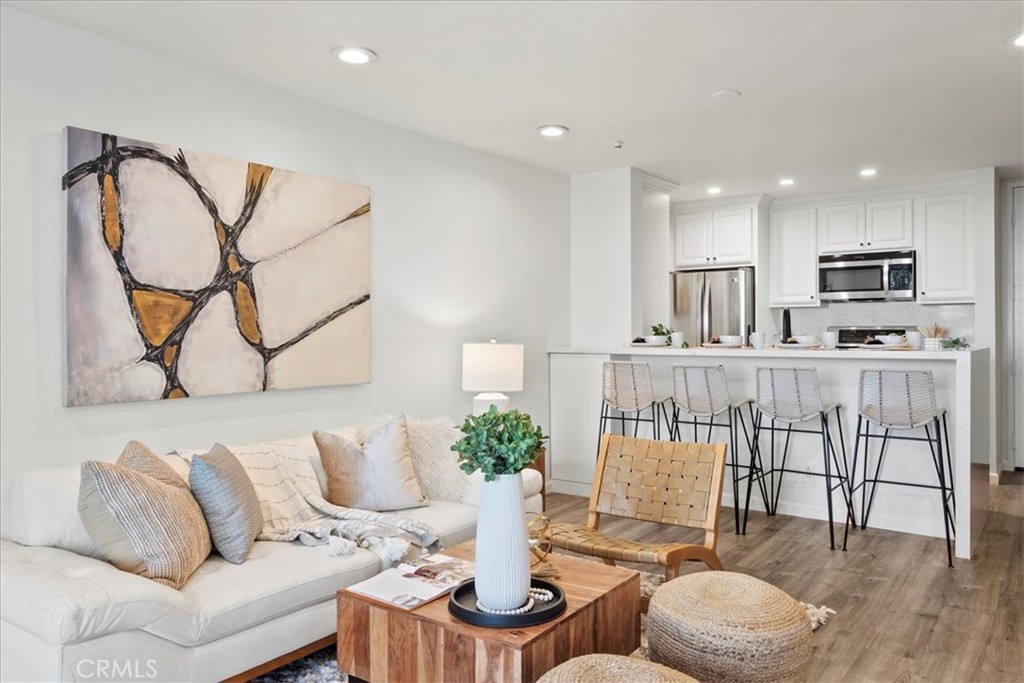 a living room with furniture a rug and white walls