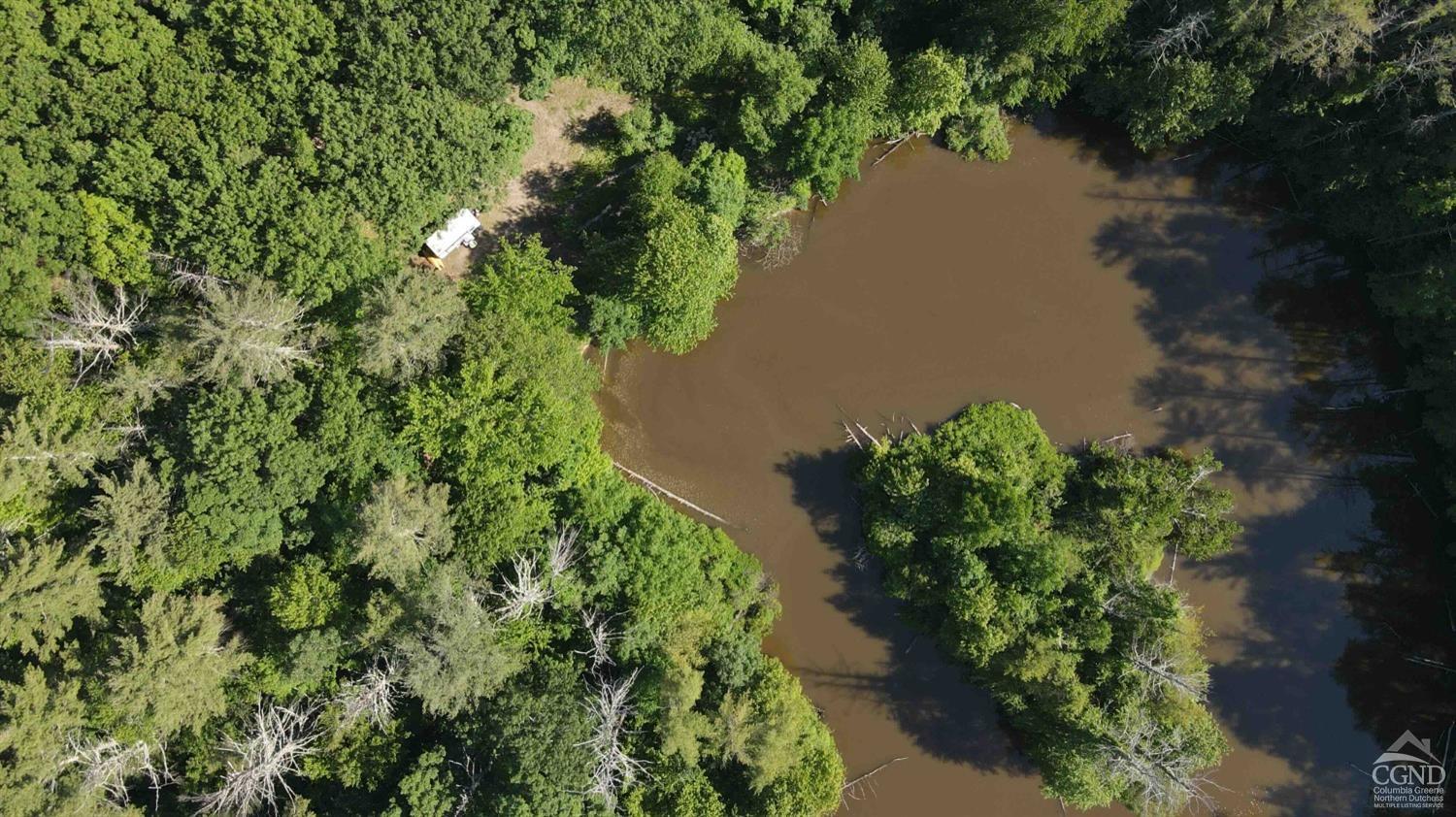 an aerial view of a house with a yard and lake view