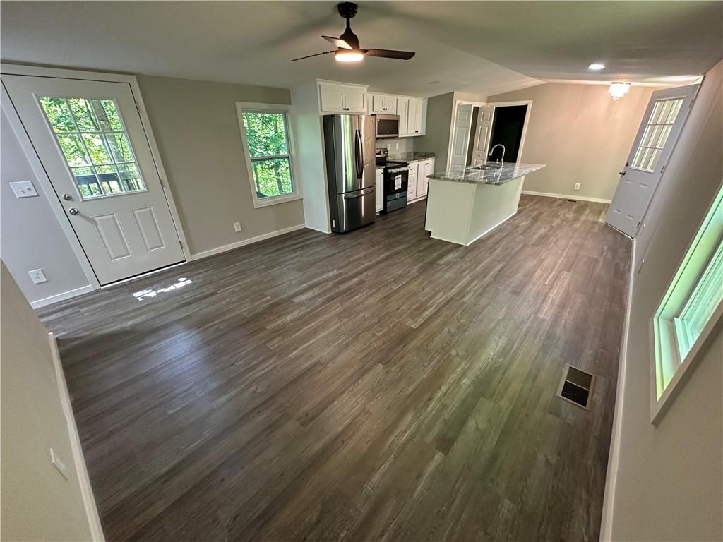 a view of kitchen with furniture and wooden floor