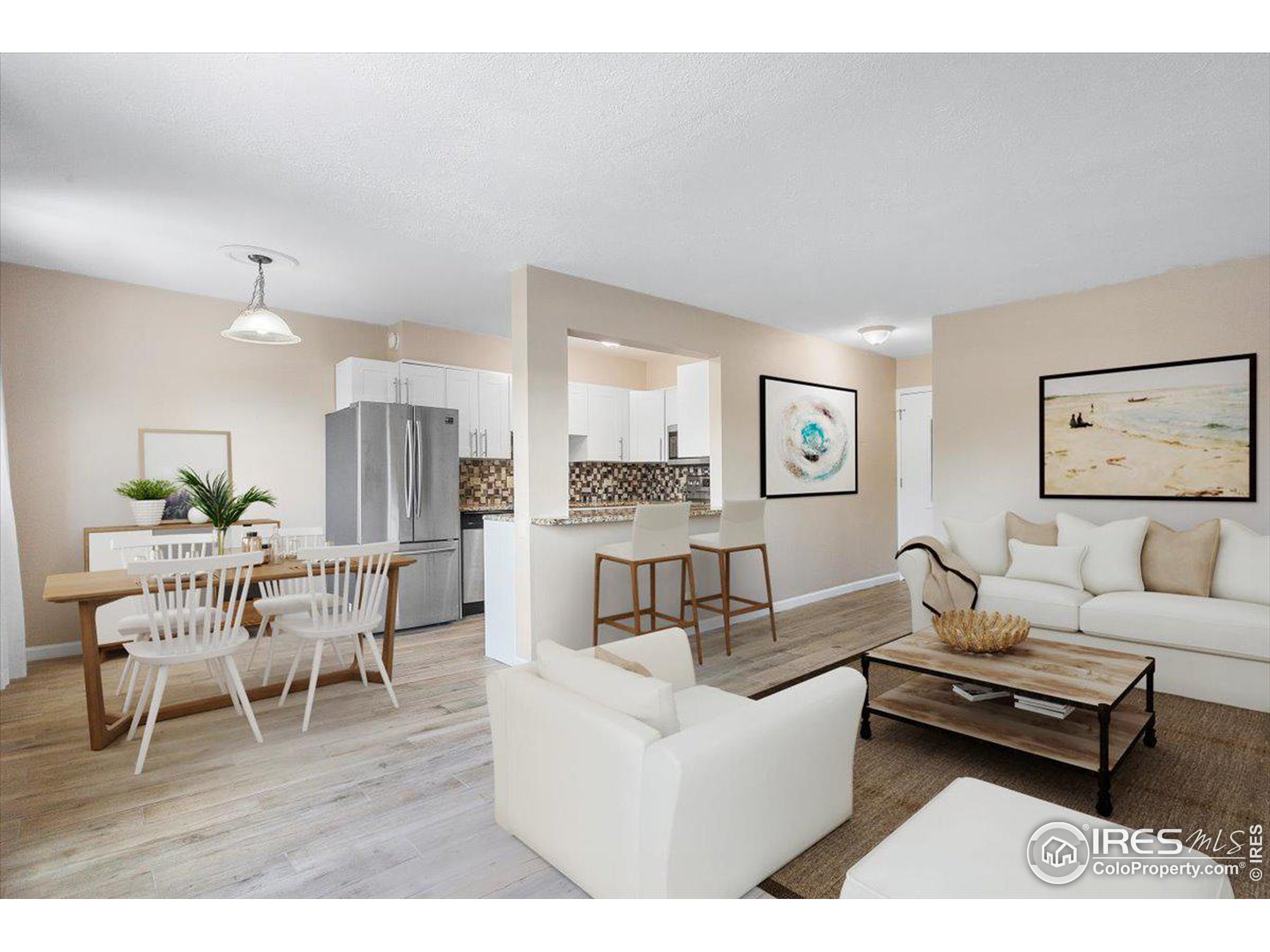 a living room with furniture wooden floor and a view of kitchen