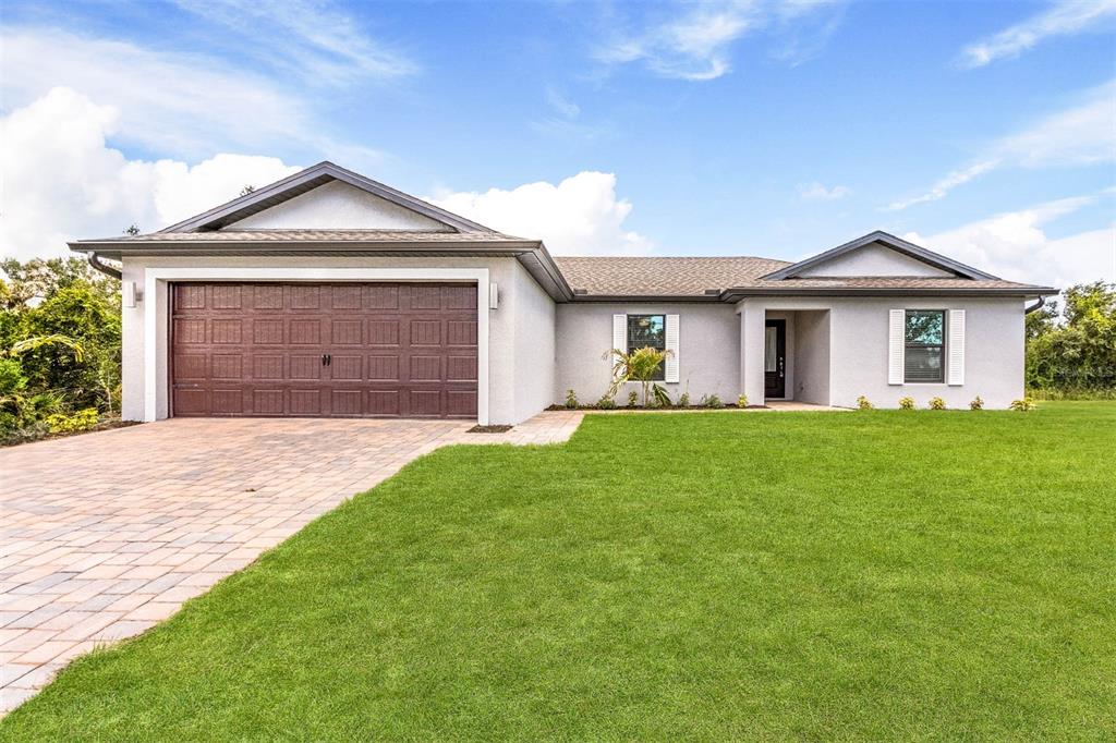 a front view of a house with a yard and garage