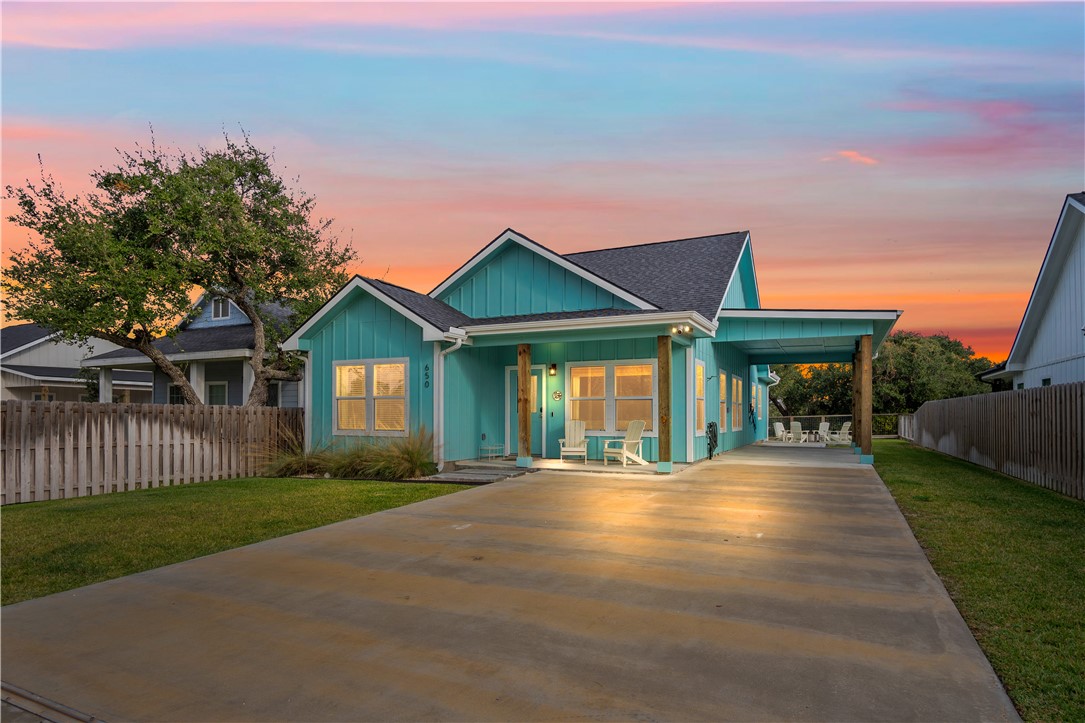 a front view of a house with a yard and outdoor seating