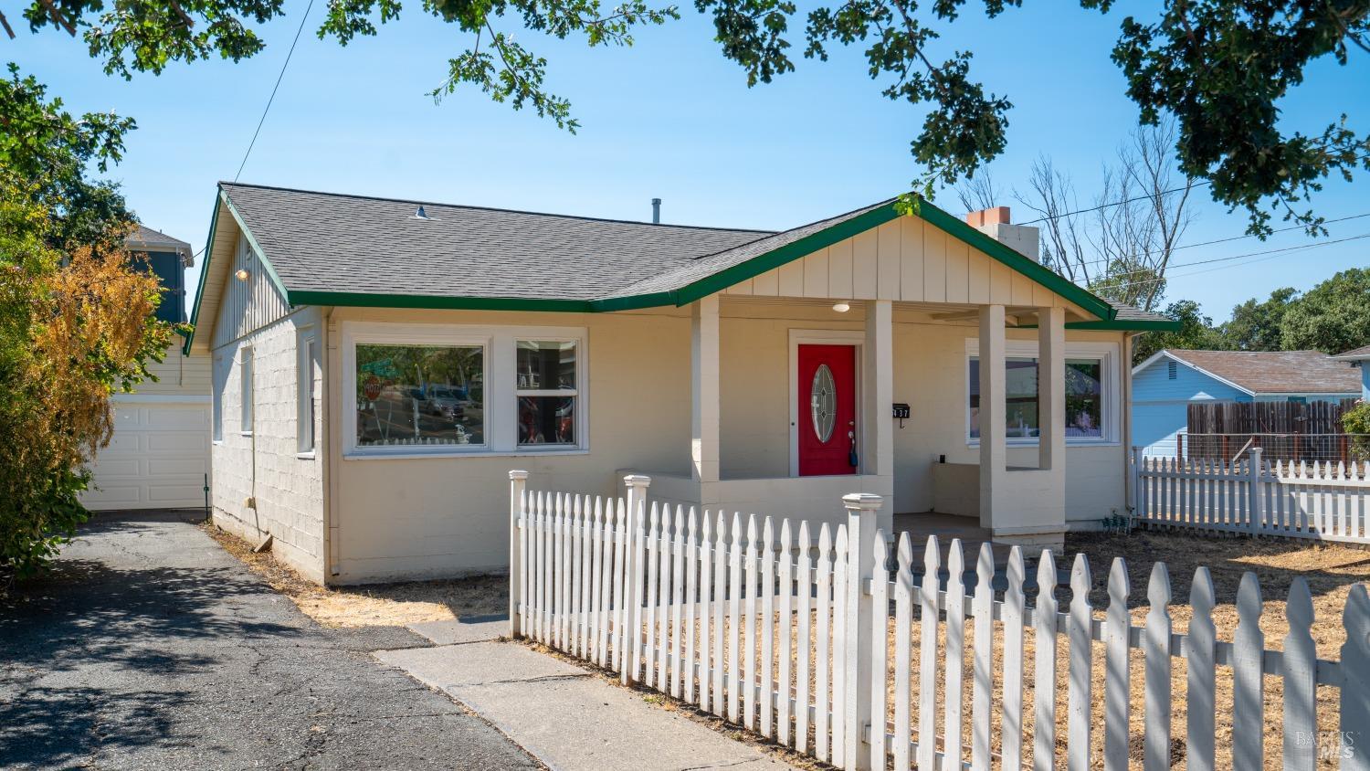 a view of a house with wooden fence