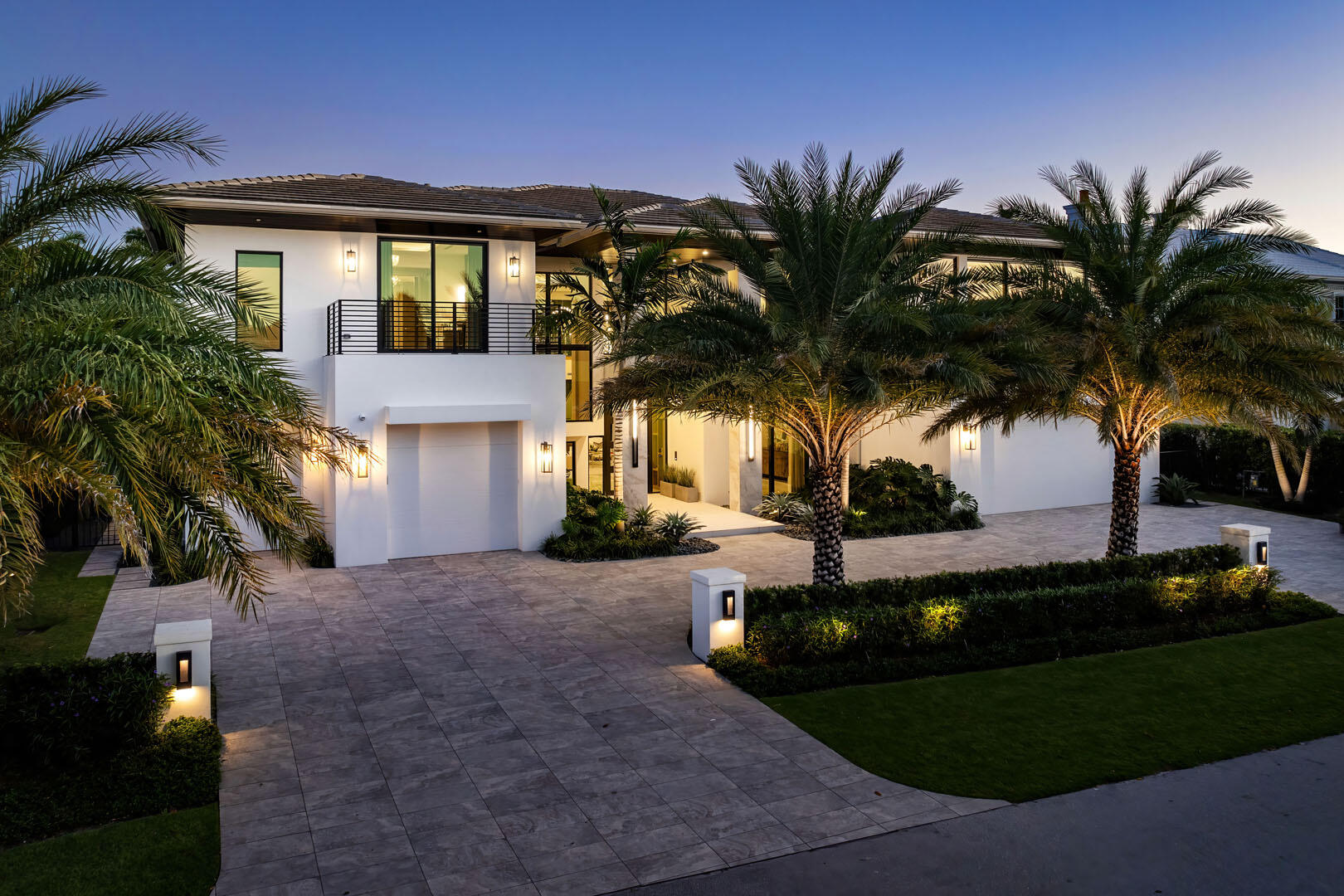 a view of a house with a yard and palm trees