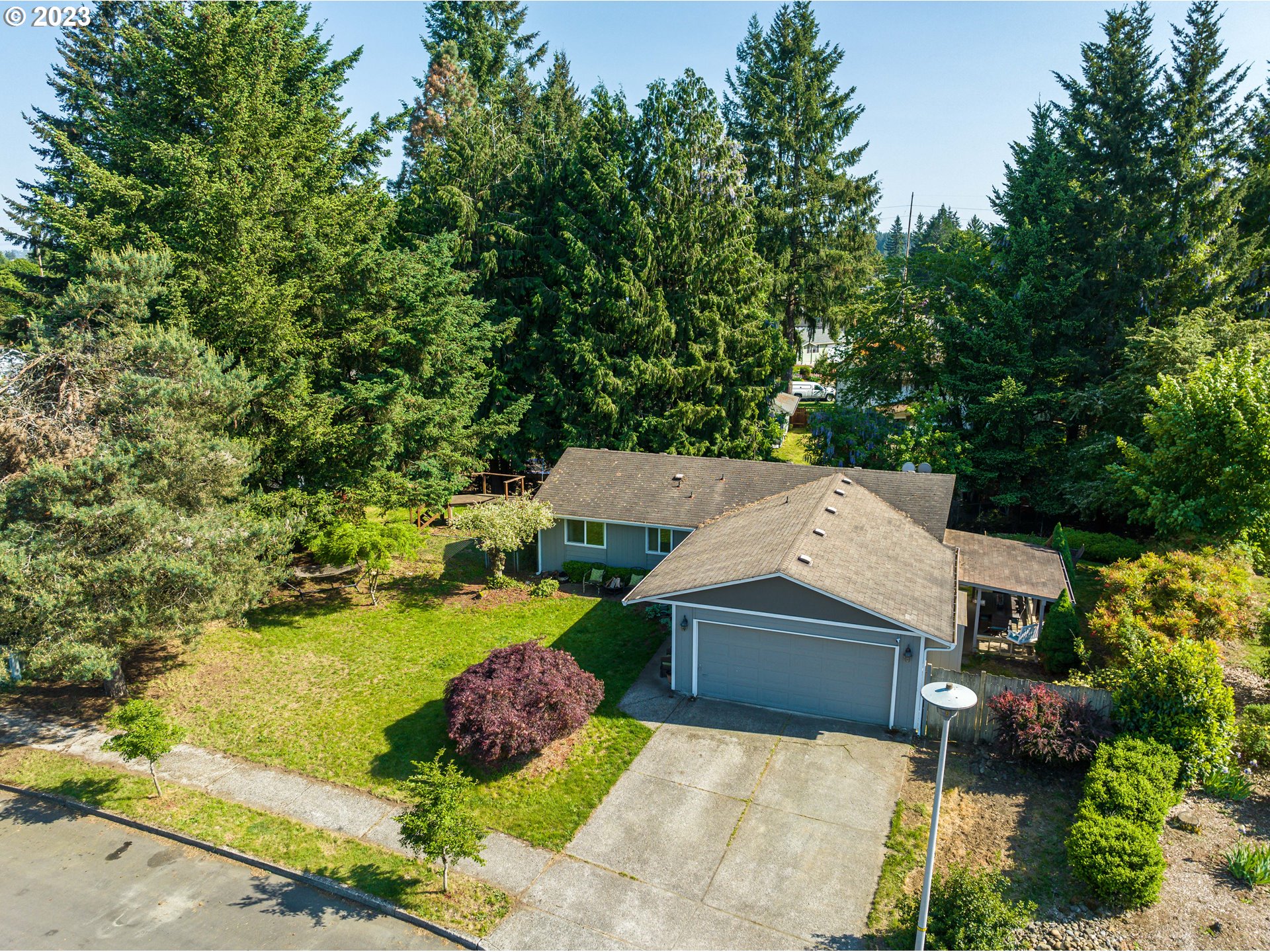 an aerial view of a house with a yard and lake view