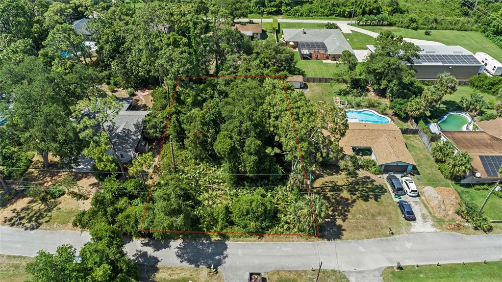 an aerial view of a house with a yard and lake view