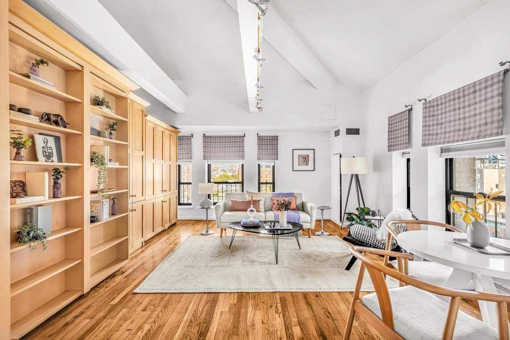 a living room with furniture a rug and a chandelier