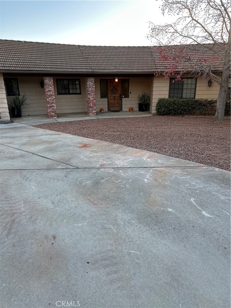 a front view of a house with a road