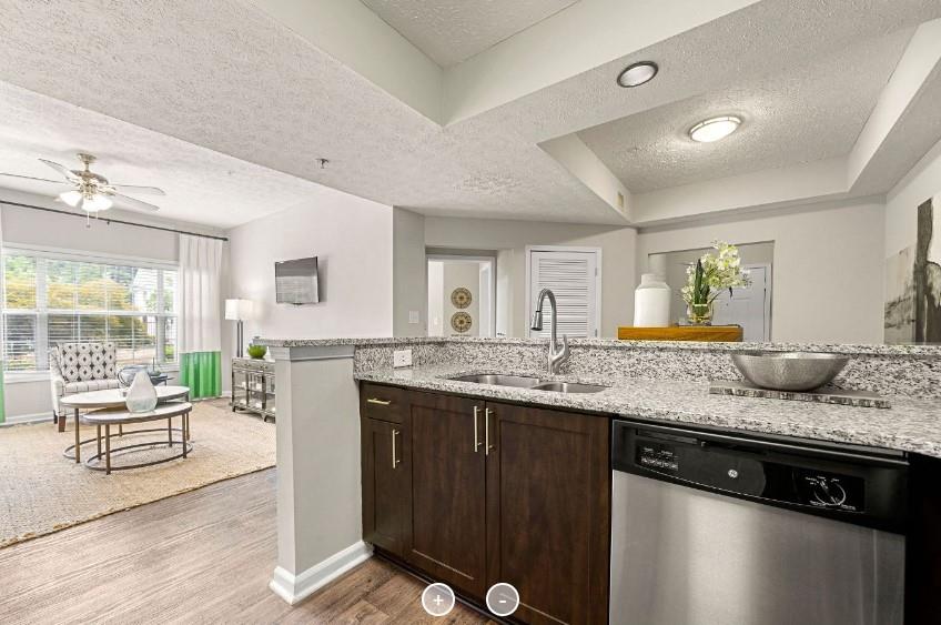 a spacious bathroom with a granite countertop sink and a large mirror