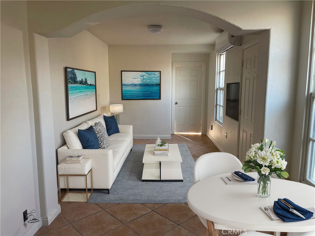 a living room with furniture and a potted plant