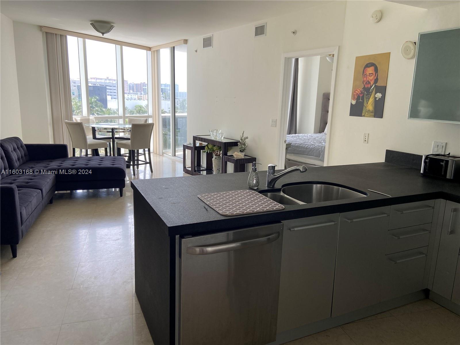 a kitchen with a sink and a large window