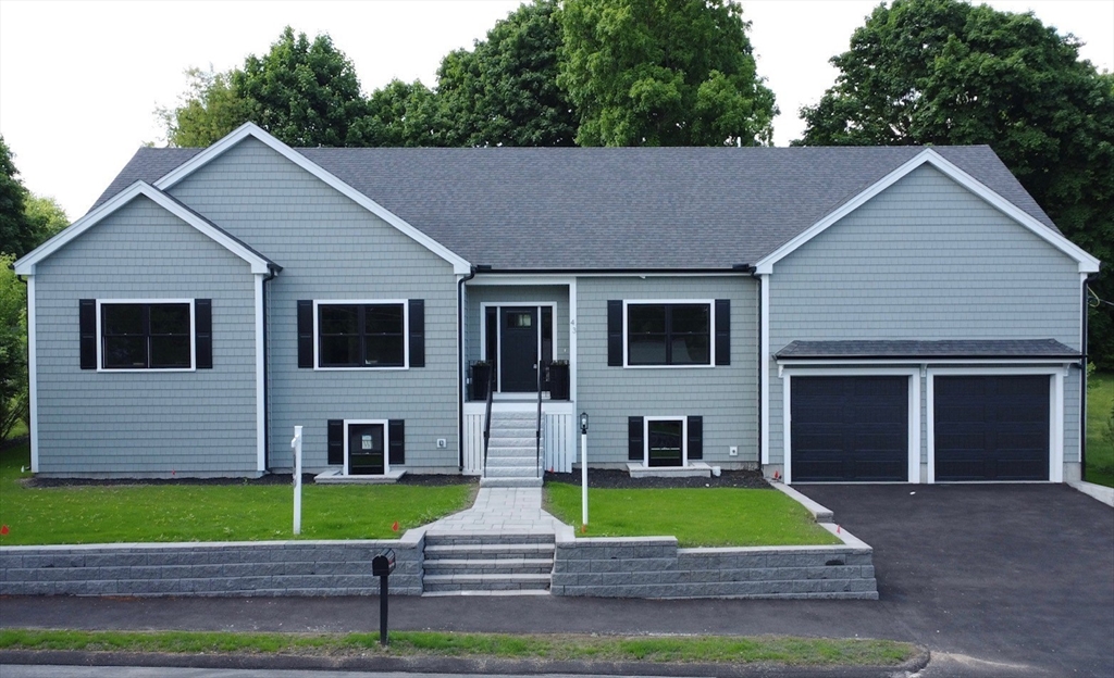 a view of house with a yard and a large tree