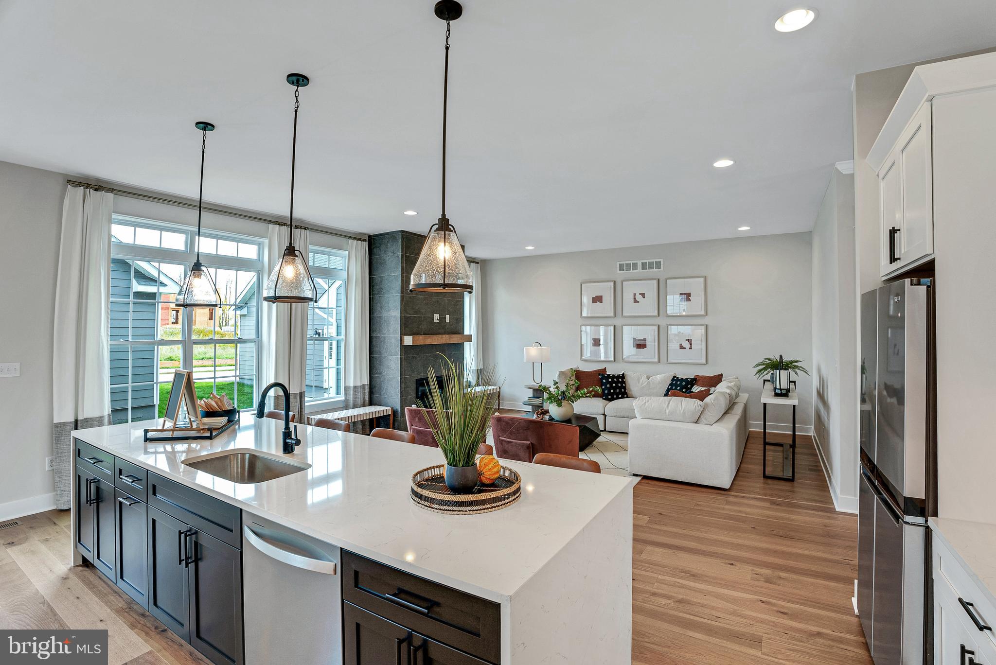 a view of a kitchen and living room with a large window