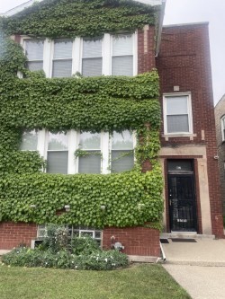 a view of a house with a yard and plants