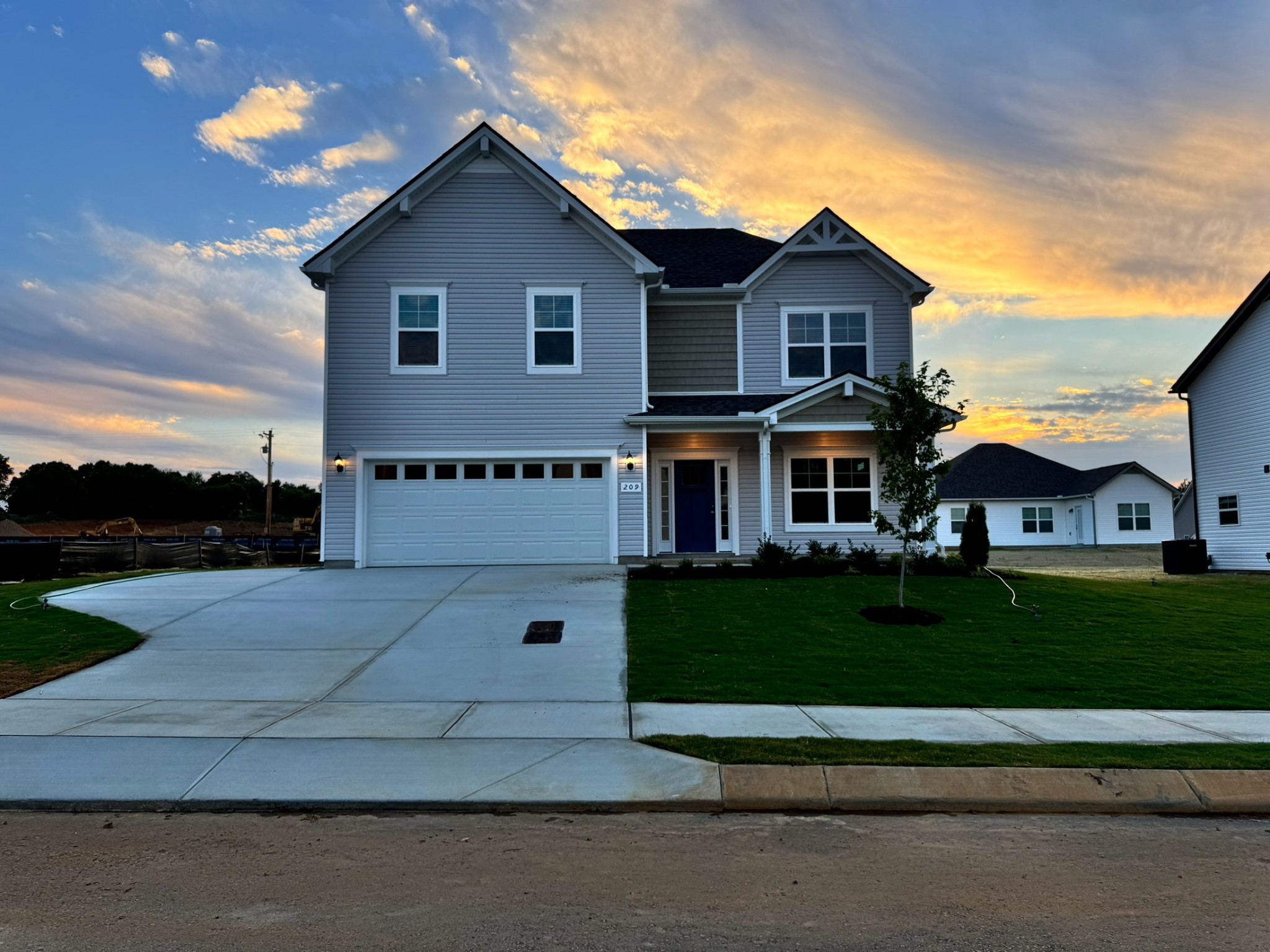 a view of house with yard and green space