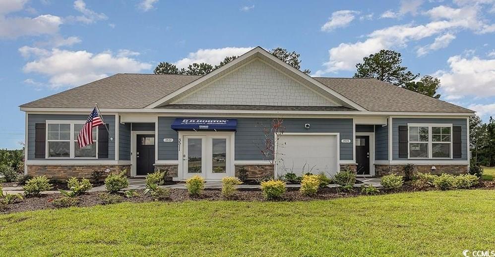 Craftsman-style house featuring a garage and a fro