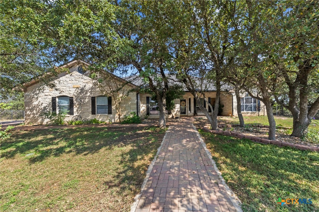 a front view of a house with yard patio and green space