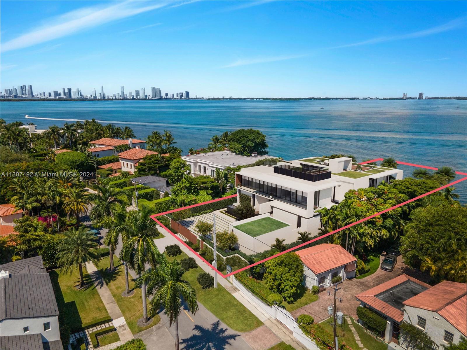 an aerial view of a house with outdoor space lake view and ocean view