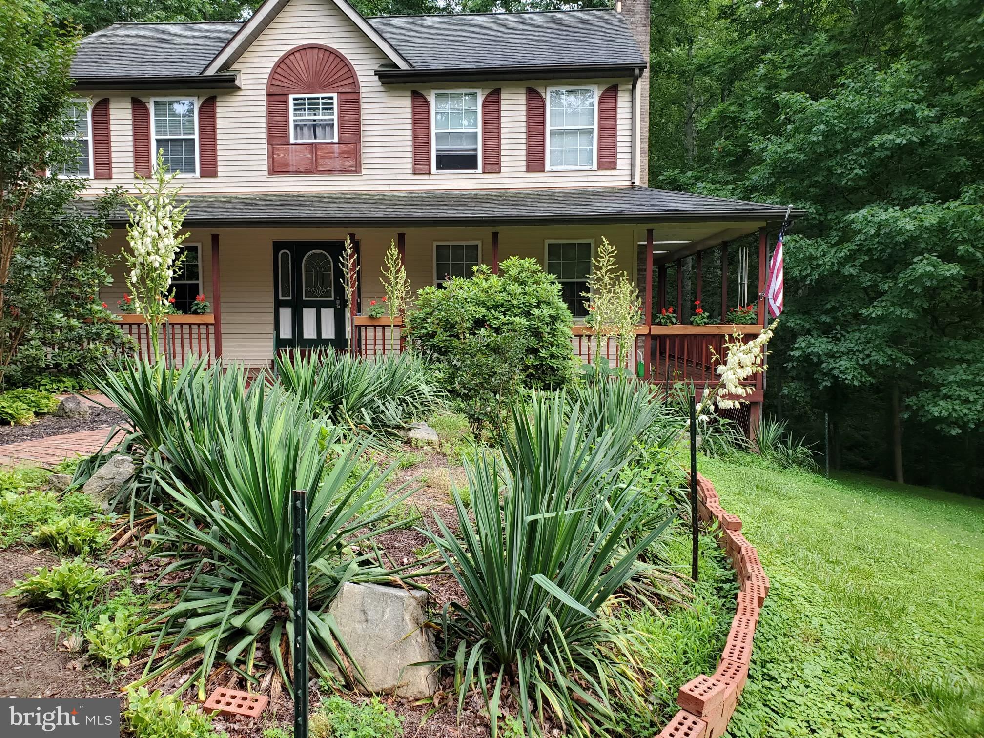 a front view of a house with a garden