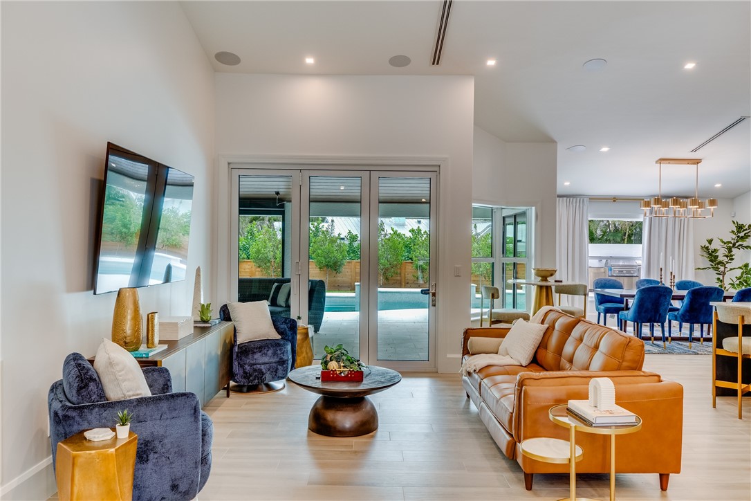 a living room with furniture fireplace and large windows