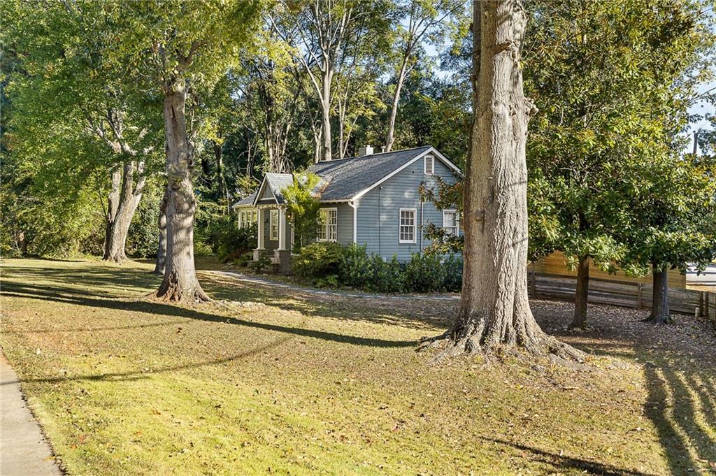 a view of a house with trees in the background