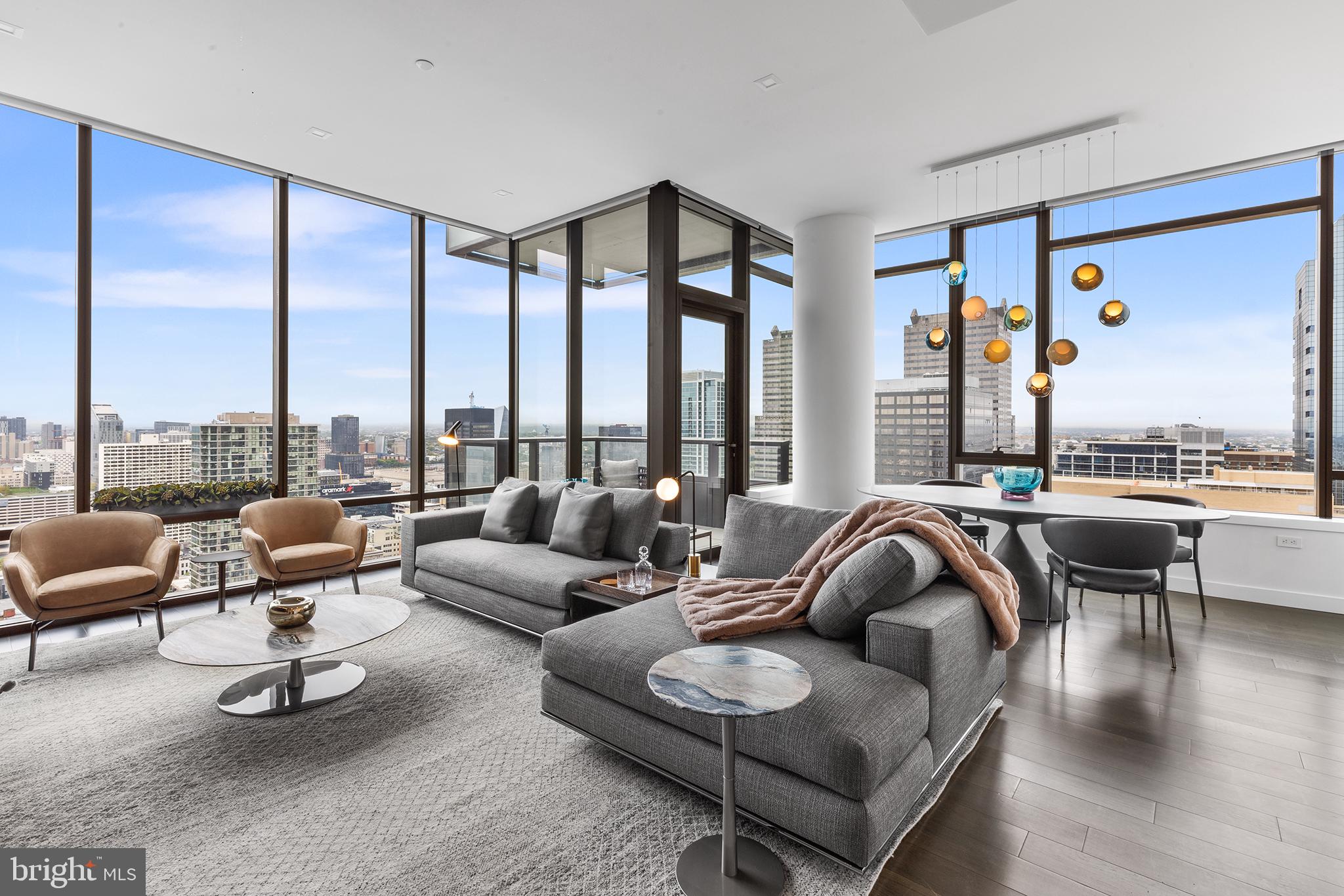 a living room with furniture and floor to ceiling windows