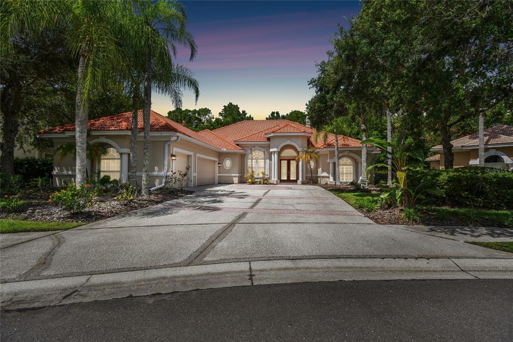 a front view of a house with a yard and garage