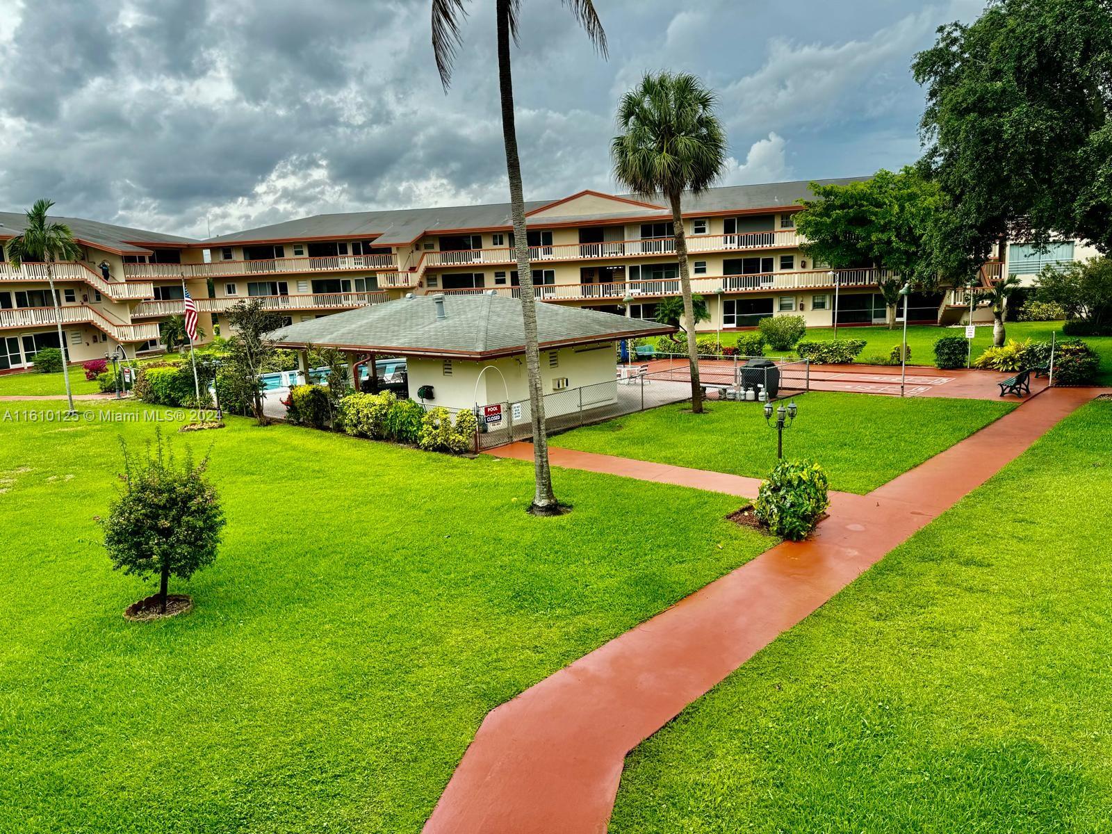 a view of yard with swimming pool outdoor seating and green space