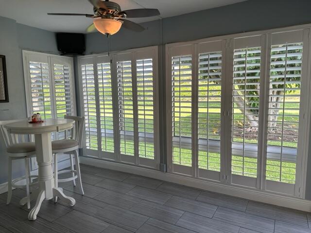 a view of a room with furniture and windows