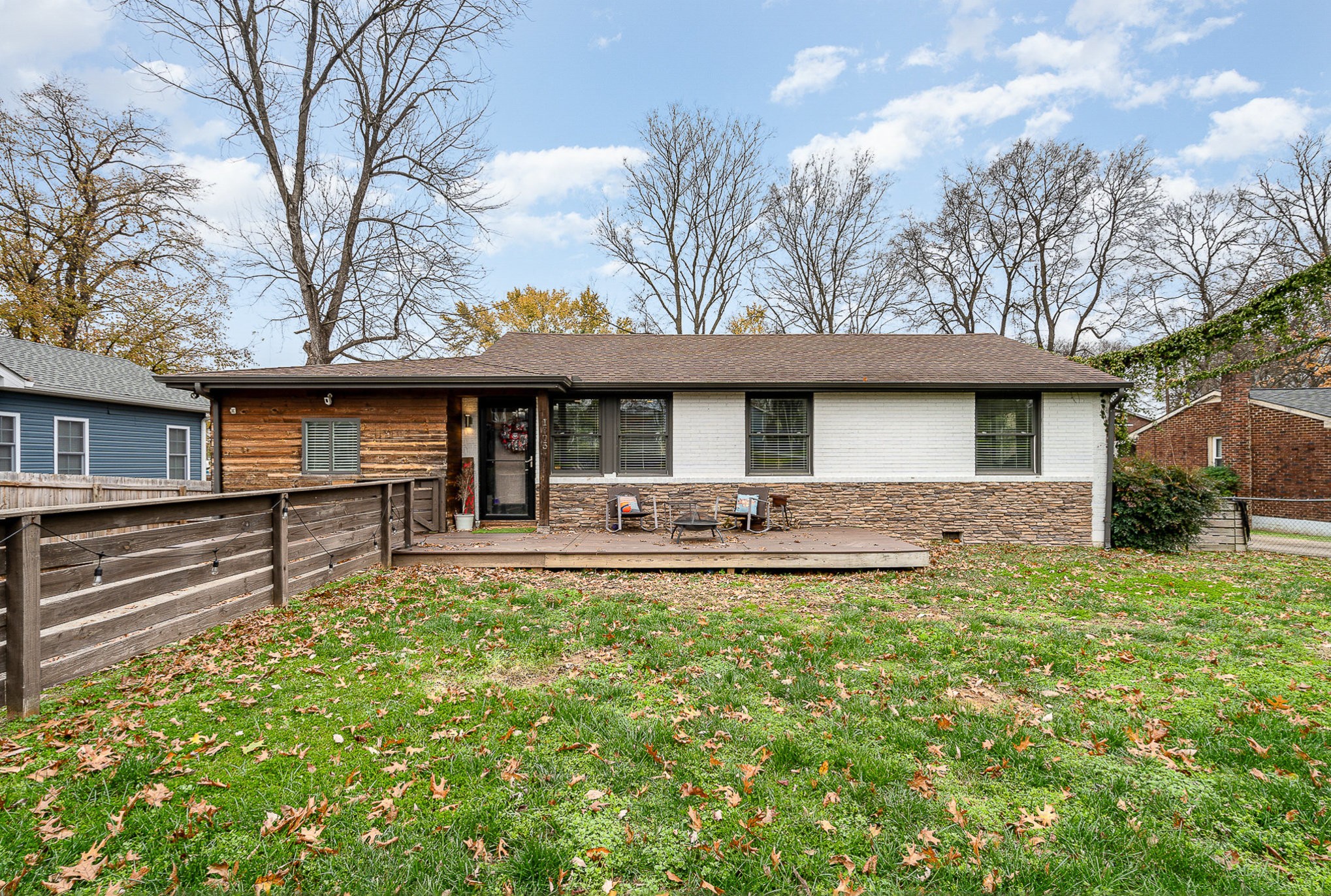 a front view of a house with swimming pool and porch with furniture