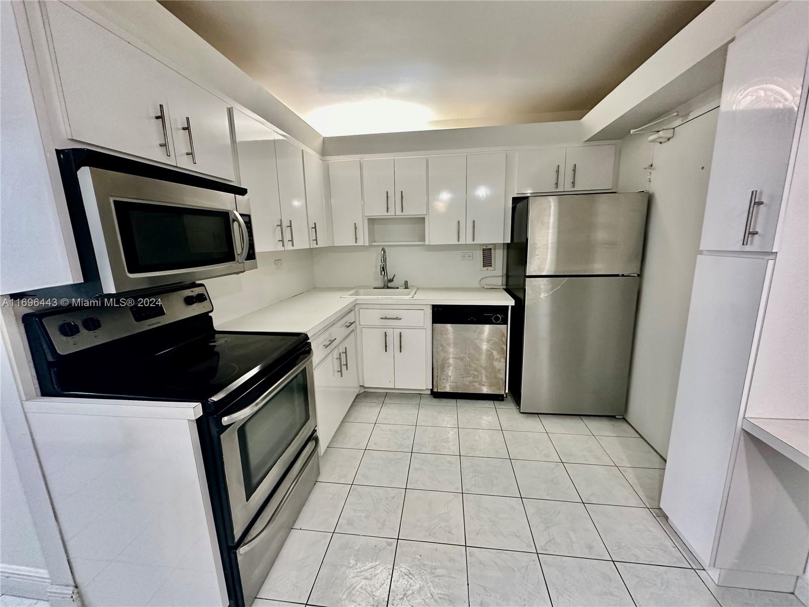 a kitchen with a stove a refrigerator and a sink