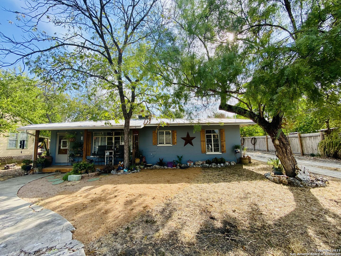 a view of a house with a yard and sitting area