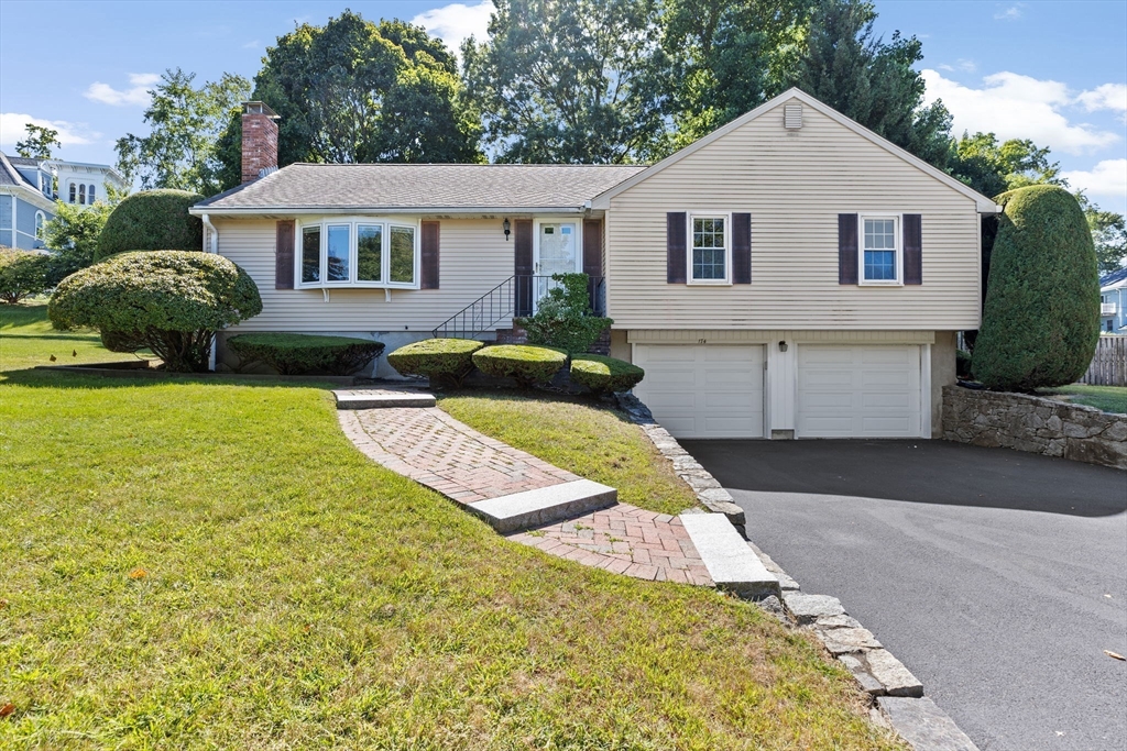 a front view of a house with garden