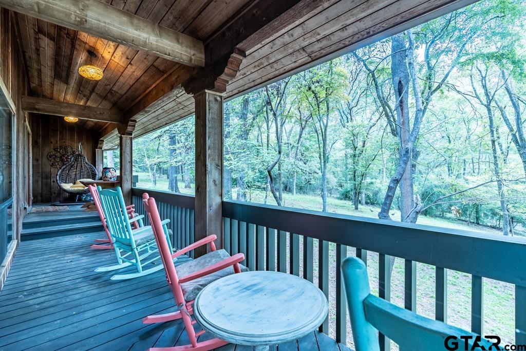 a view of a chairs and table in the balcony