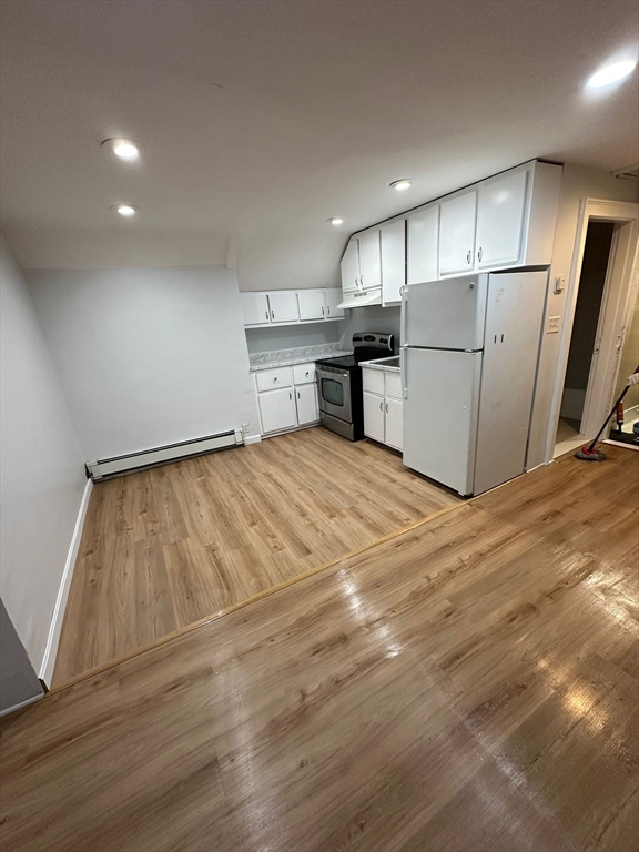 a view of a kitchen with a sink and refrigerator