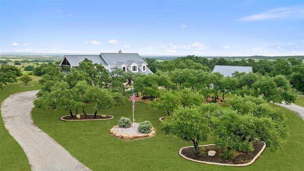 a backyard of a house with a yard and outdoor seating