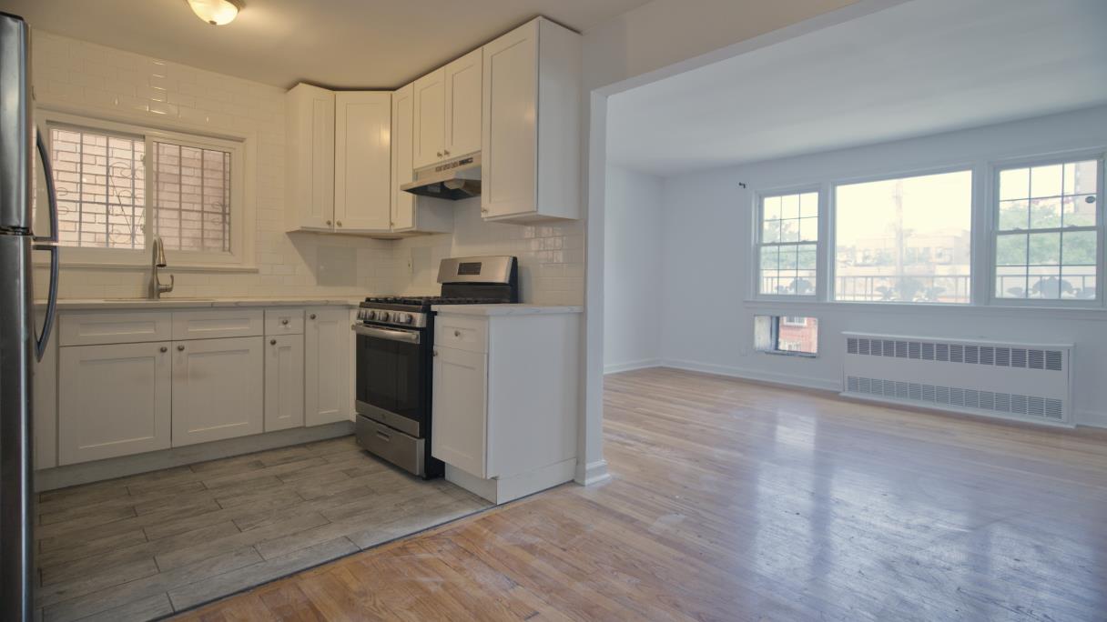 a view of a kitchen with a sink dishwasher and wooden cabinets