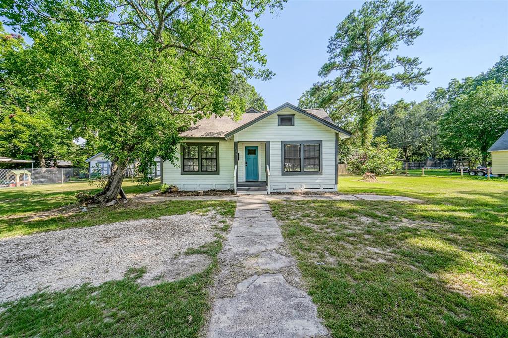 a front view of a house with yard and green space