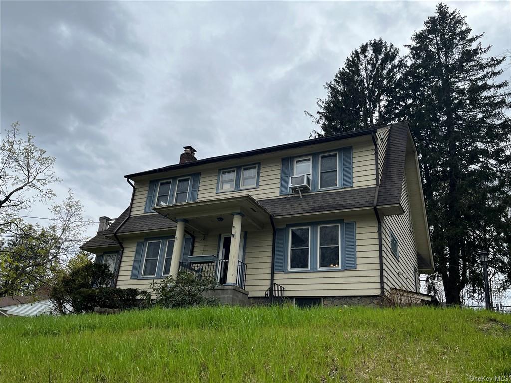 a front view of a house with a garden and plants