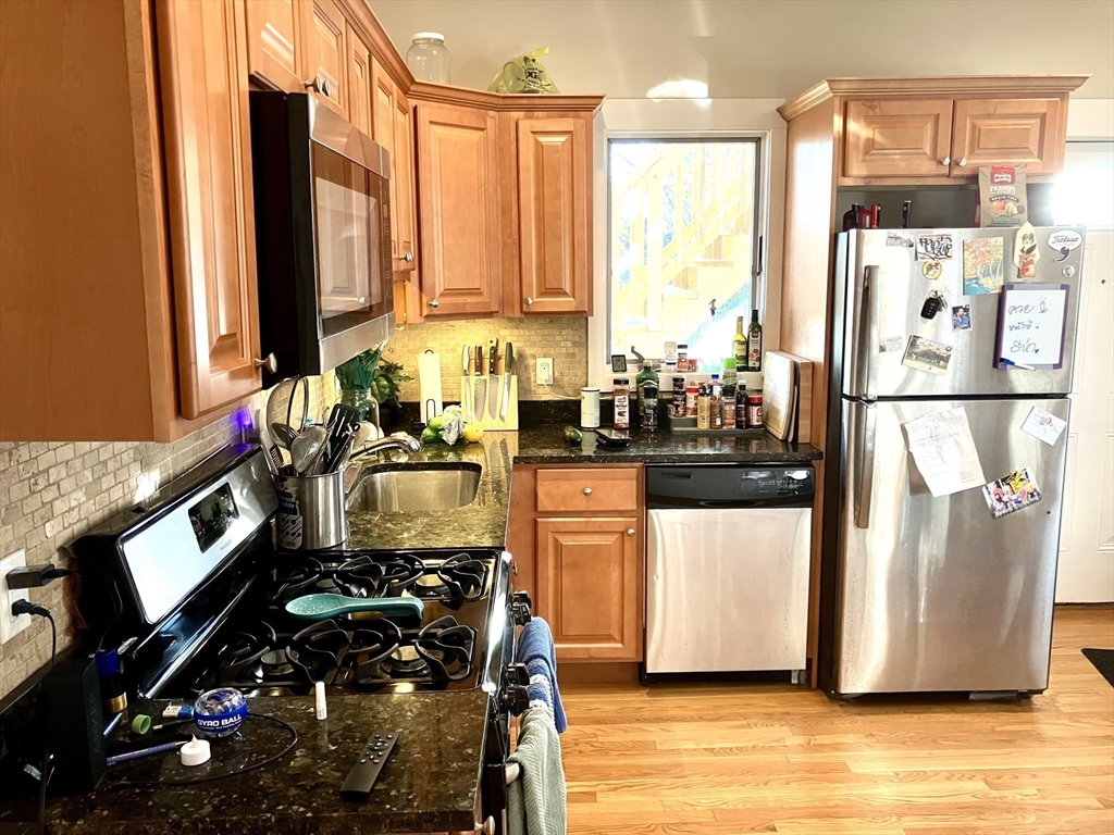 a kitchen with stainless steel appliances a refrigerator sink and cabinets