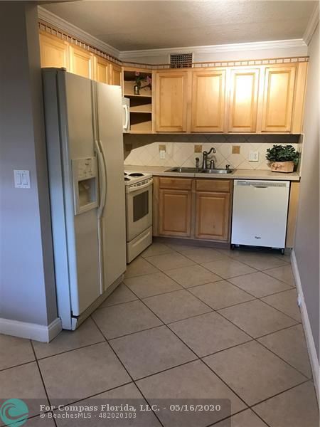 a kitchen with a stove a sink and a refrigerator