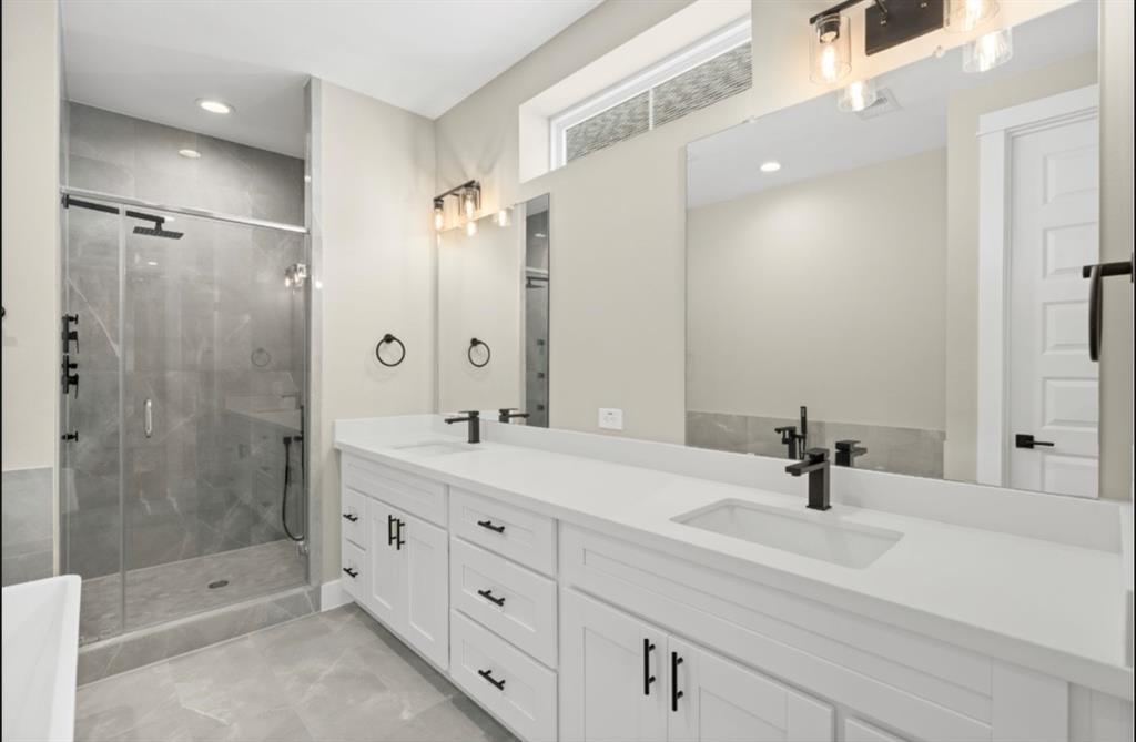 a bathroom with a shower sink double and mirror