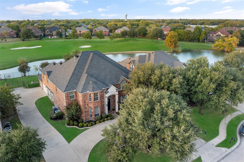 an aerial view of a house with a garden and lake view