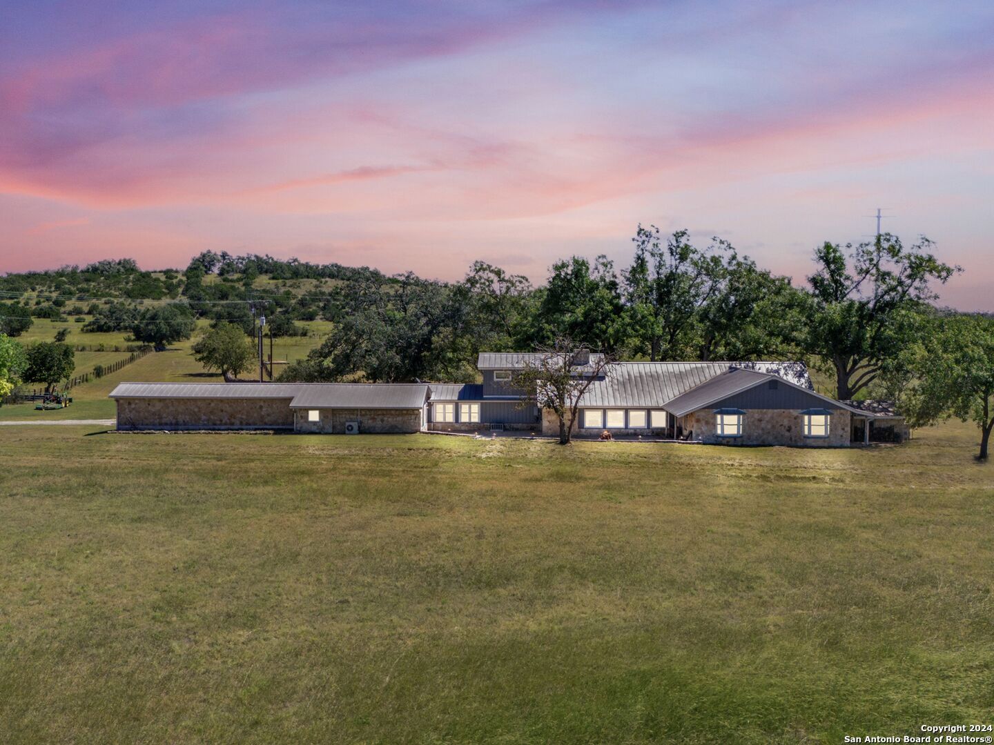 a aerial view of a house with a yard basket ball court and outdoor seating