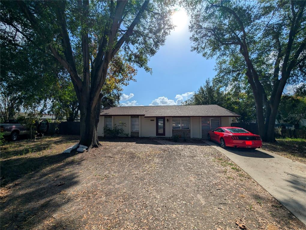 a front view of house with yard and trees